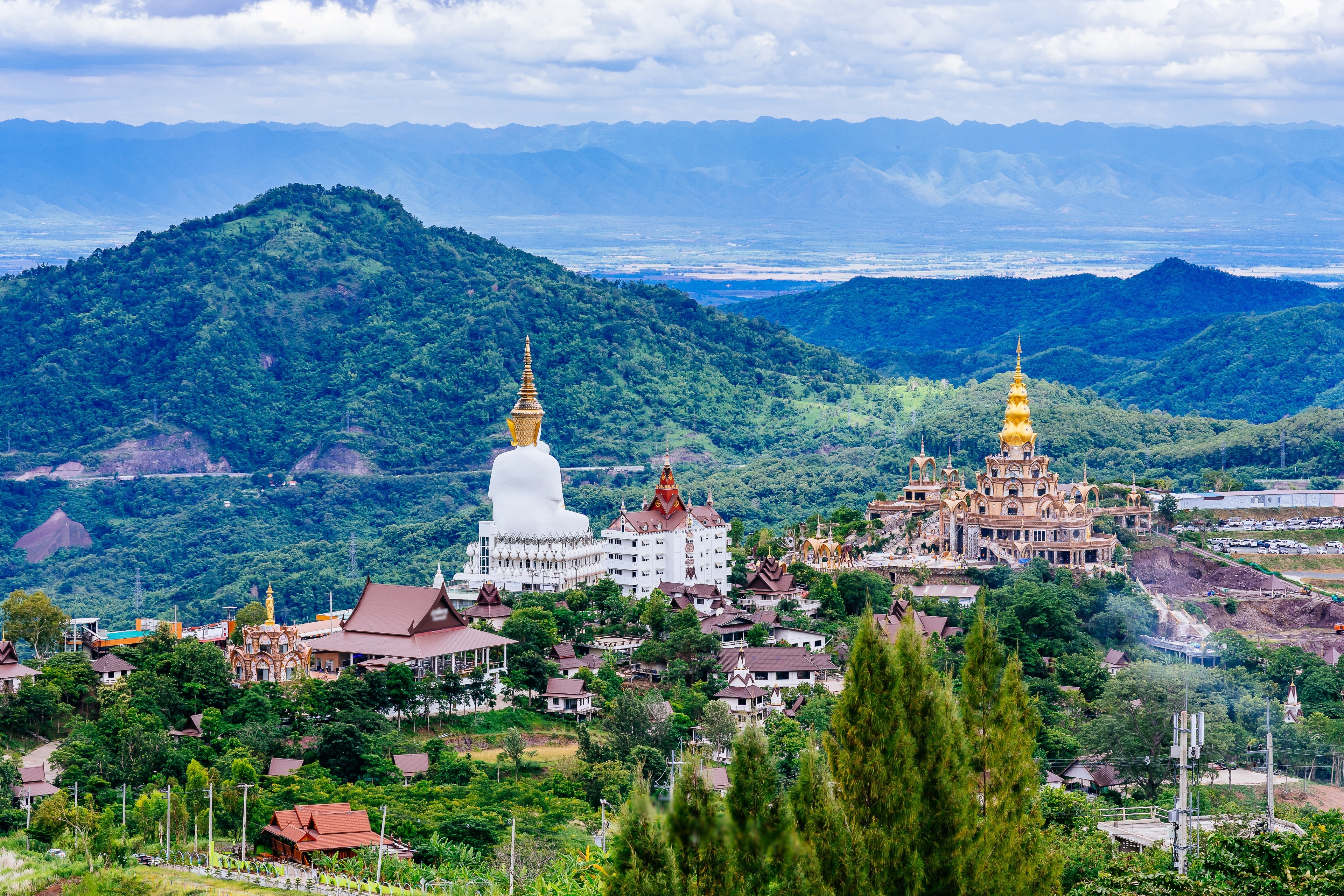 A statue of Bhudda surrounded by lush jungle in Phetchabun, Thailand.
