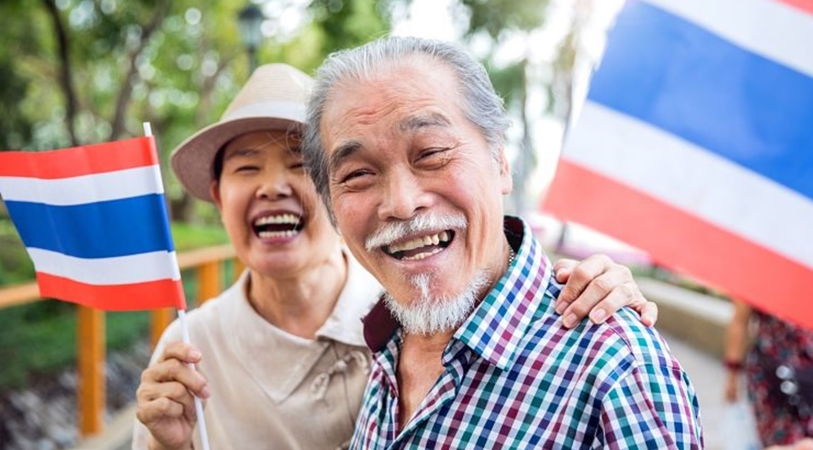 A Thai man and woman smiling at the camera