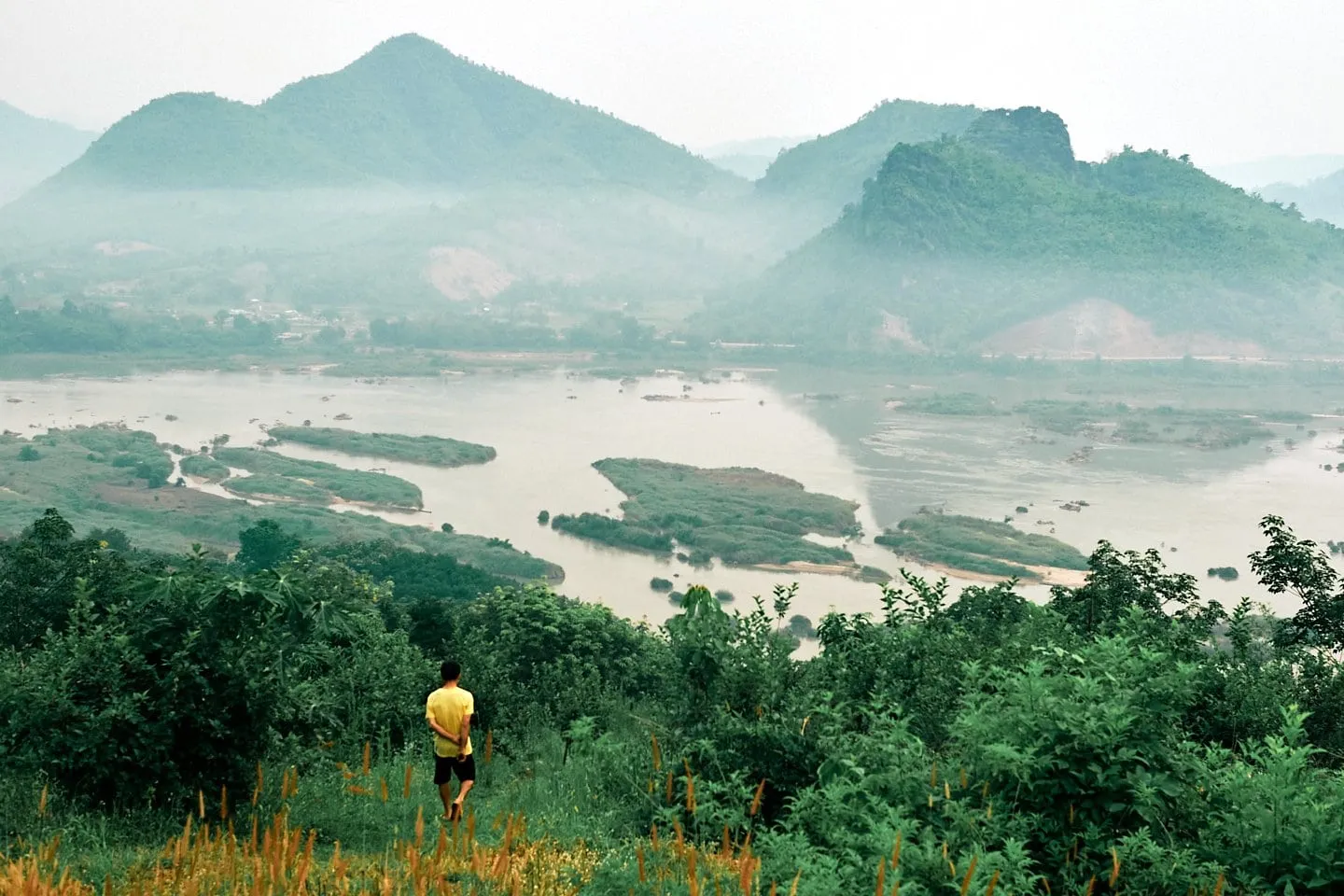 A view across a lake surrounded by lush green mountains.
