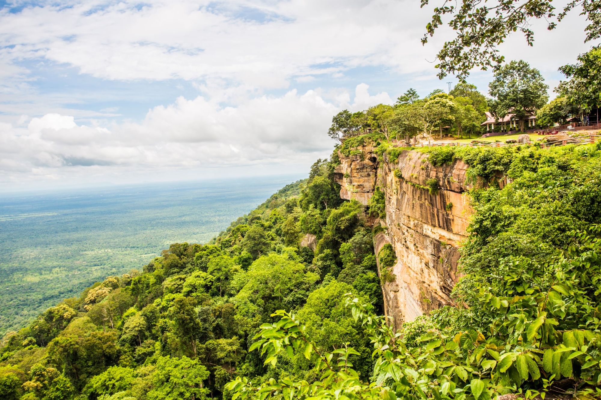 A flat mountain ledge overlooking lush green jungle.