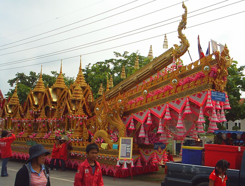 A gold and red rocket festival float.