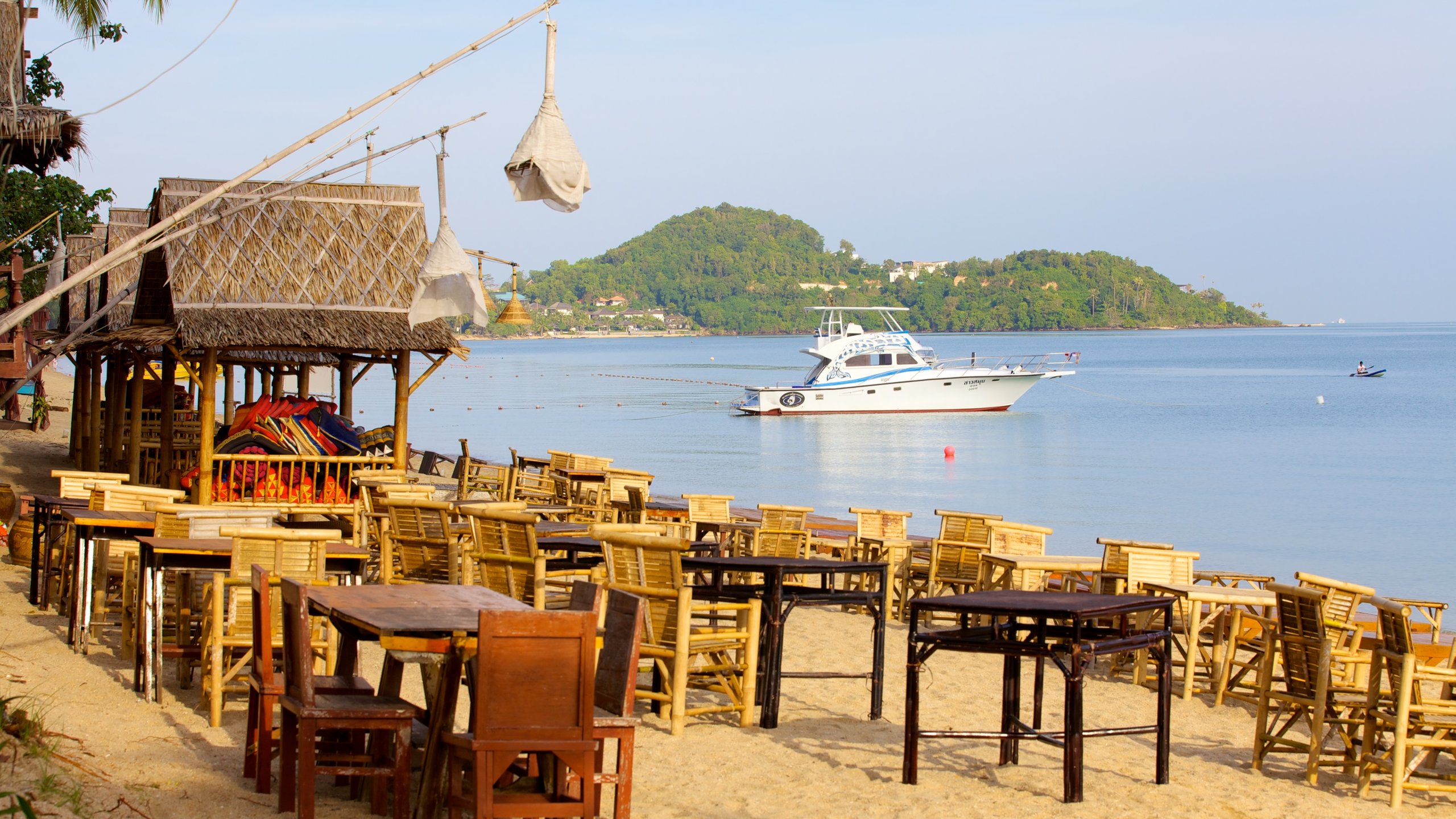 Tables and chairs on a sandy beach