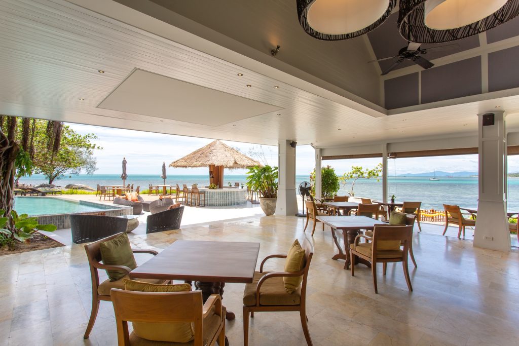 An open air restaurant looking out onto the sea